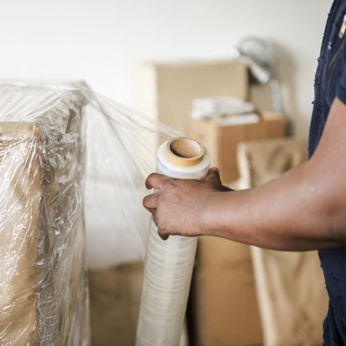Black man moving furniture